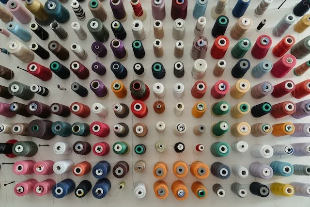 Photograph of spool threads in many different colours for how to make custom embroidered patches