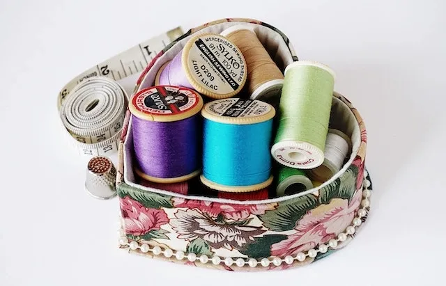 Small box filled with sewing paraphernalia for how to make custom embroidered patches