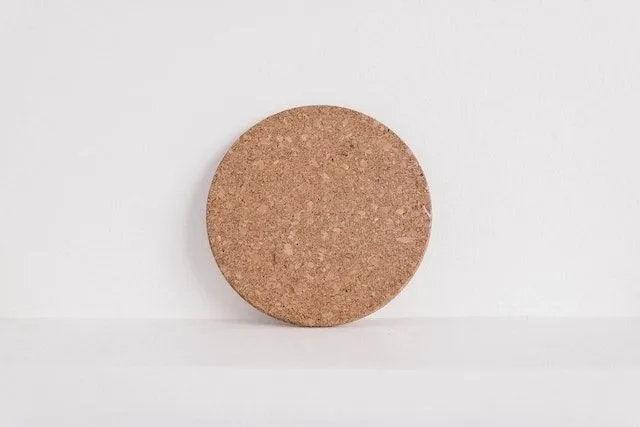 A circle made of cork with white background for how to clean cork coasters