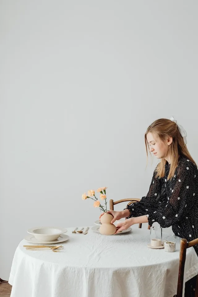 Woman arranging table over tablecloth for best tablecloths for events