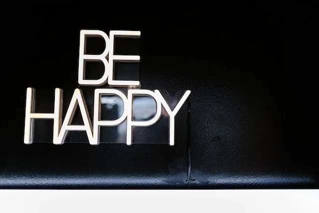 Neon sign displaying the message “Be Happy” for how long do neon signs last