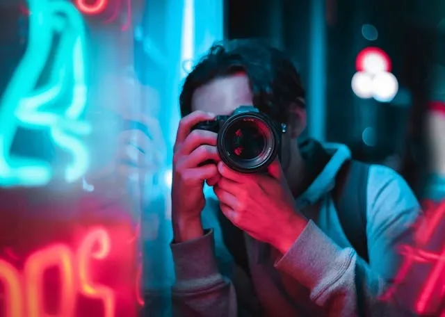 a photo of a person using a camera for neon photoshoot ideas