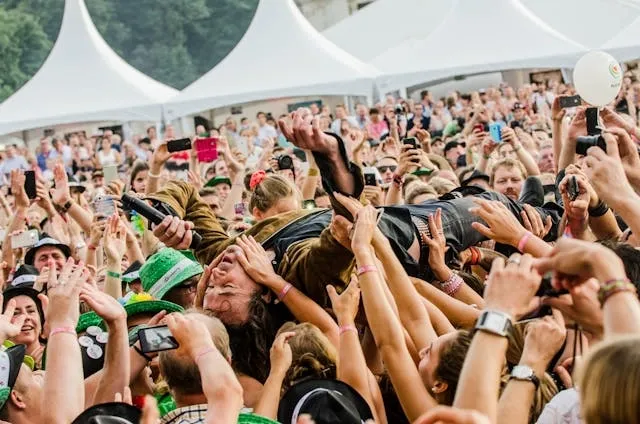 a musician crowdsurfing for how to loosen festival wristband