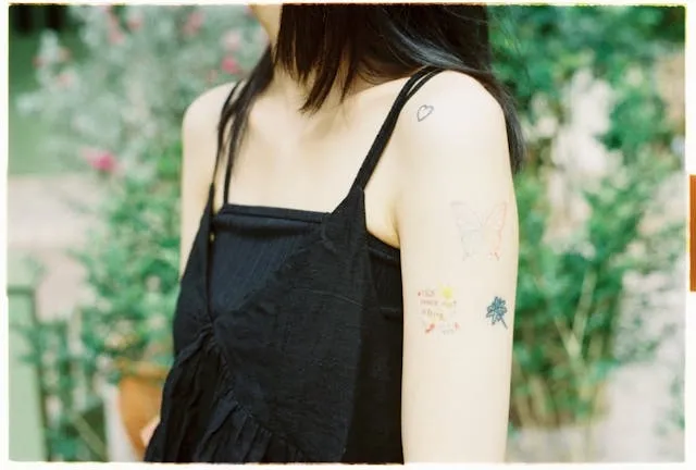 a person wearing a black top for custom temporary tattoos long lasting