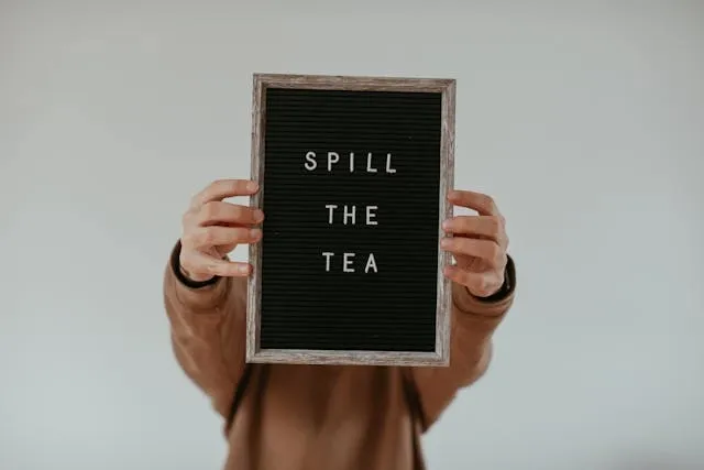 a person holding a light-hearted sign for funny restaurant signs