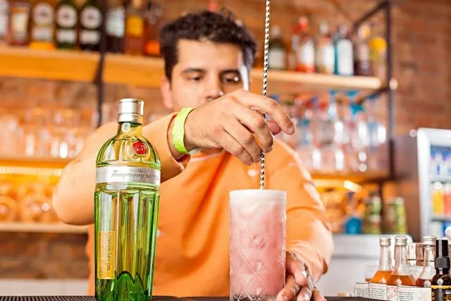 a person mixing a cocktail for best barware gifts