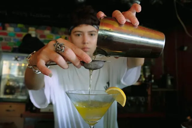 a person mixing a drink for how to measure a shot without a shot glass