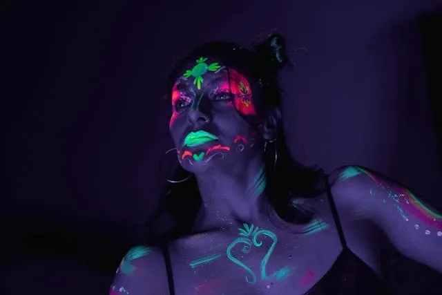a person wearing neon body paint for do neon colors glow under black light