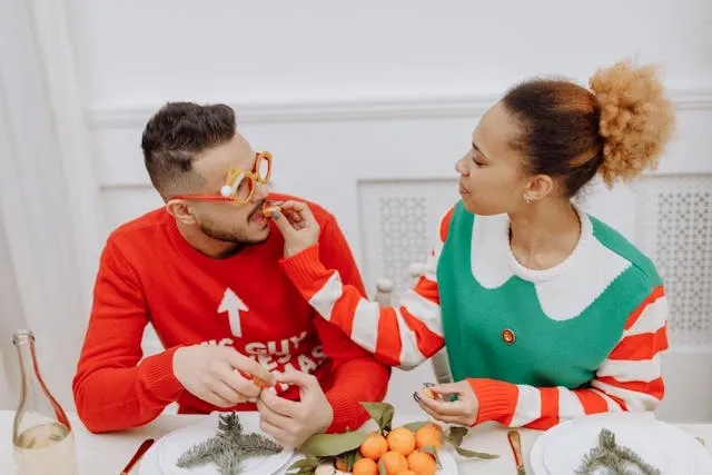 a happy couple in christmas jumpers for christmas proposal ideas