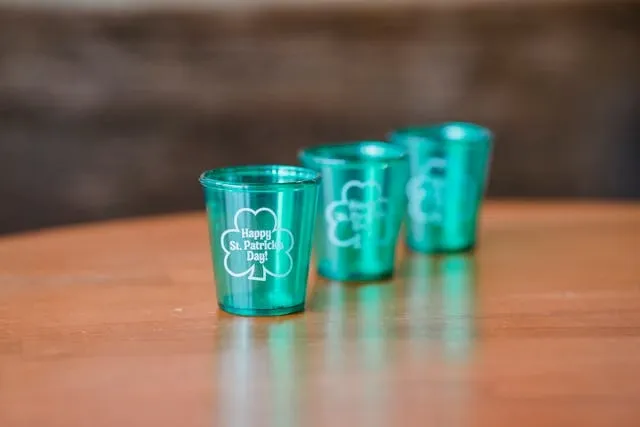 a row of green shot glasses for how many tablespoons in a shot