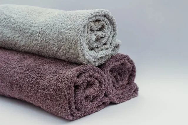 a small pile of towels for how often should you wash your towels