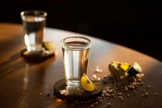 a pair of tequila shots on a table for shot glass measurement