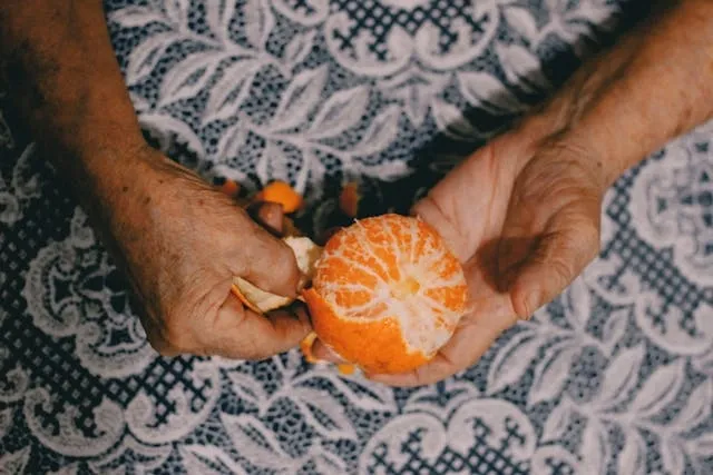 peeling an orange over a lace tablecloth for how to get stains out of old tablecloths
