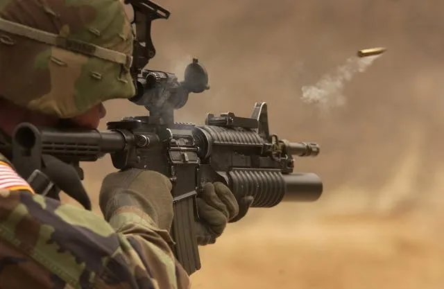 a soldier firing a rifle for yin yang army patch