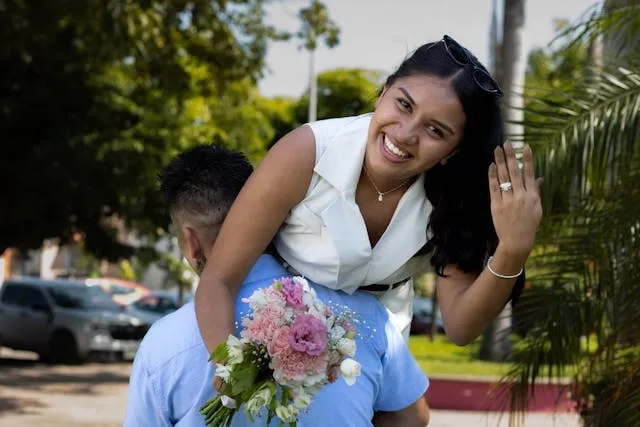 a person showing off an engagement ring for outdoor proposal ideas