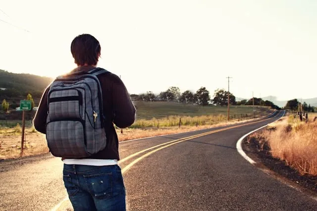 a person looking at the open road for standard backpack size