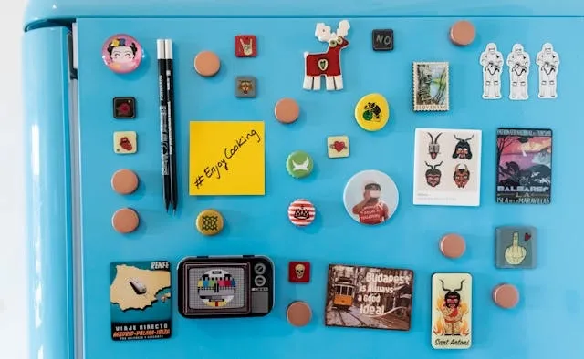 colorful magnets on a blue refrigerator for do magnets stick to stainless steel