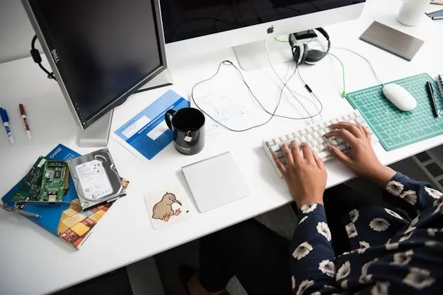 a person working at a computer for can you wash mouse pads