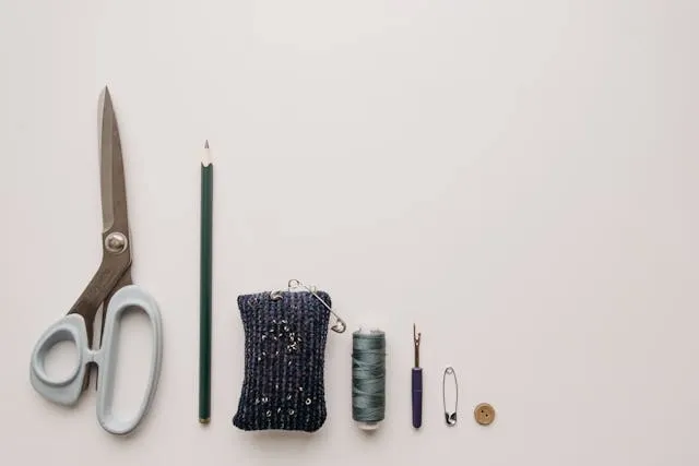 a flatlay of sewing materials for how to remove an embroidered patch from a jacket