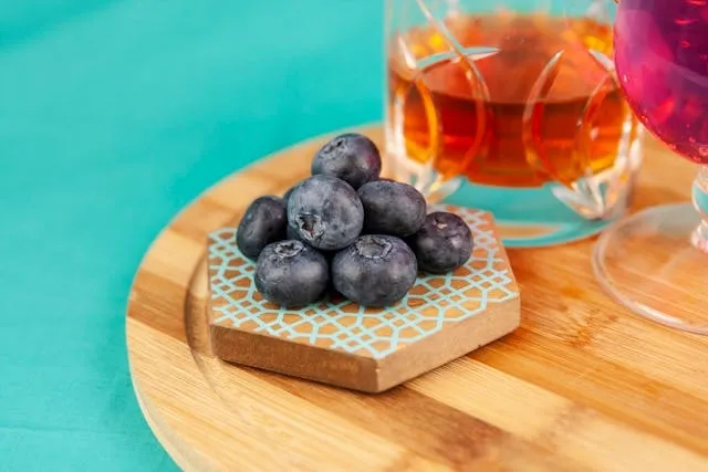 a patterned wood coaster with blueberries for cricut coaster ideas