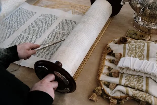 a person reading from the torah for diy bar mitzvah centerpieces