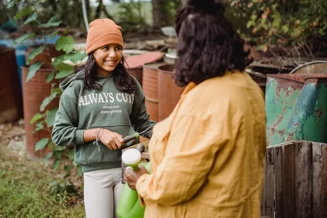 a parent and child holding gardening tools outdoors for embroidered sweatshirt ideas