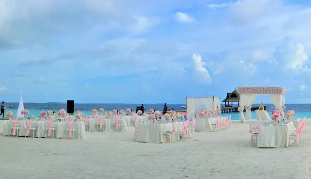covered tables on a tropical beach for how to make your wedding unique and unforgettable