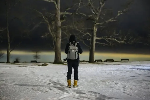 a solitary figure in a snowy wintry landscape for how much weight can a backpack hold