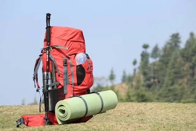 a red hiking backpack on grass for types of backpacks