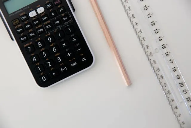 a black calculator near a ruler for how to measure a poly mailer for shipping