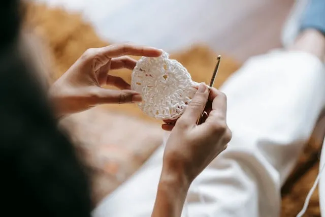 a person crocheting at home for how to crochet a coaster