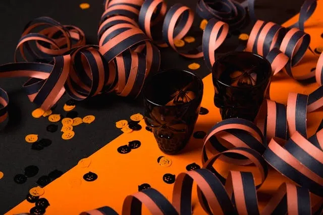 a selection of orange and black party decorations for streamer decoration ideas
