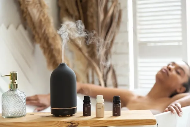 a person bathing beside an aroma diffuser for air freshener safe for cats