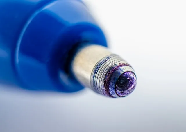 a super macro shot of the tip of a ballpoint pen for how to remove ballpoint ink from clothes