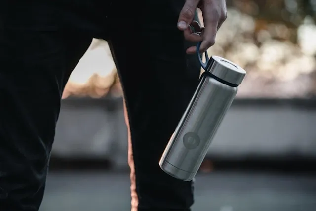 someone carrying a metallic water bottle for how to clean water bottle