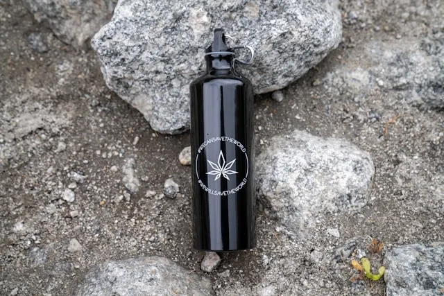 a black tumbler on the ground outdoors for how to seal vinyl on tumblers