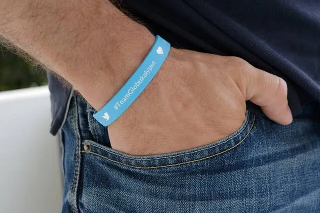 a person wearing a blue wristband with a hand in their pocket for how to shrink rubber bracelets