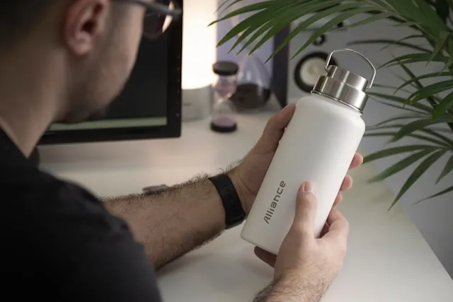 a person looking at a printed tumbler for how to remove sublimation ink from tumbler