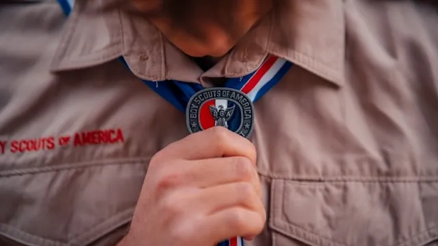 someone wearing a bsa badge for how to attach boy scout patches