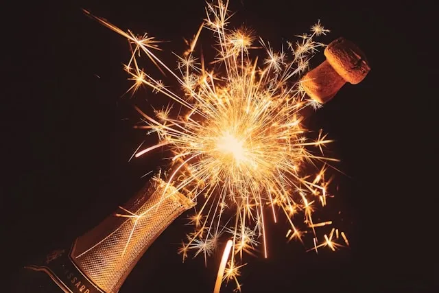 a champagne bottle opening with a sparkler effect for gifts for champagne lovers