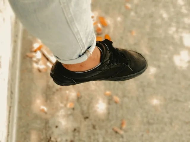 a person wearing a black barefoot shoe for do you wear socks with barefoot shoes