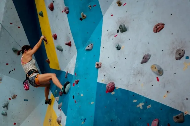 a person on a climbing wall for do you wear socks with climbing shoes