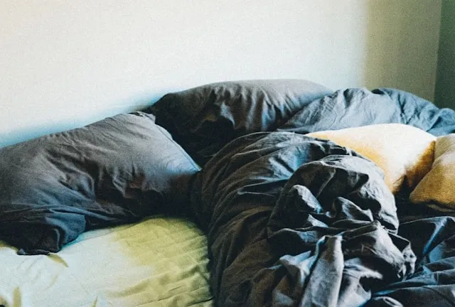 a crumpled duvet on a bed for duvet vs blanket