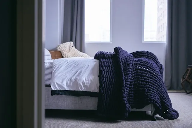 a bed with a thick blanket on top for throw vs blanket