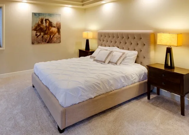 a bed in a room for queen size blanket dimensions