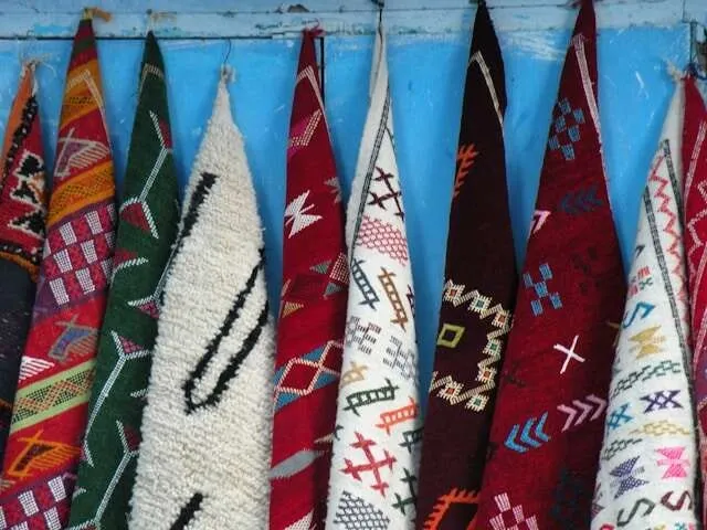 a selection of blankets hanging from hooks for how to wash wool blanket