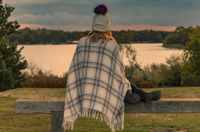 a person using a blanket outdoors for duvet vs comforter vs blanket