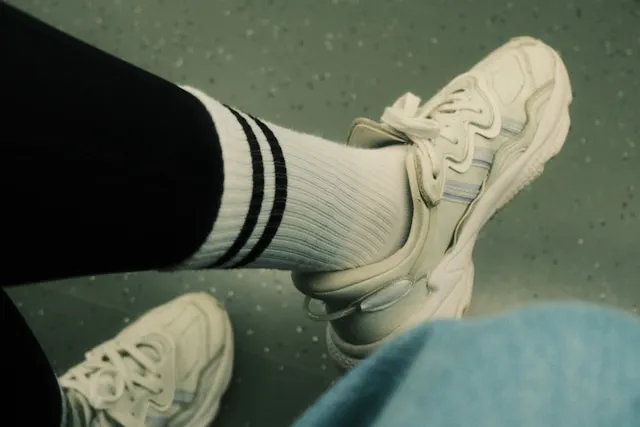 a person wearing white gym socks and trainers for how to clean white socks