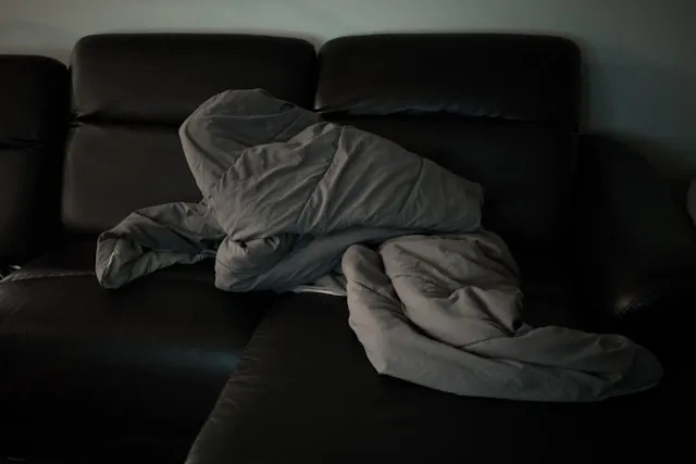 a crumpled duvet on a couch for duvet vs comforter vs blanket