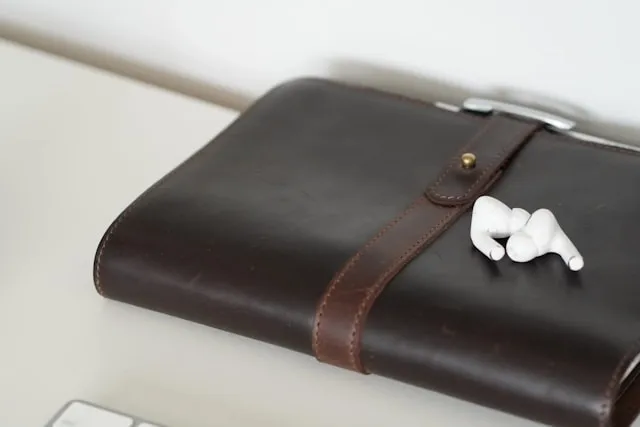 a work organizer and some earbuds for what is a padfolio